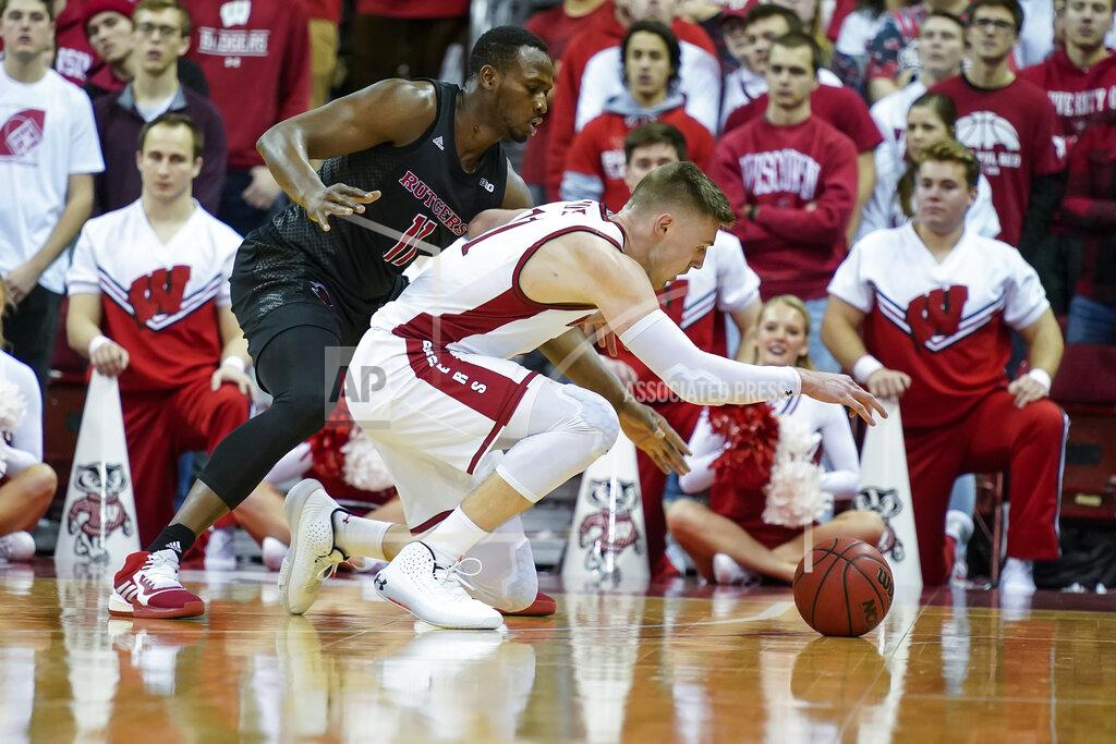 Andy Manis Rutgers' Mamadou Doucoure, left, and Wisconsin's Micah Potter go after the ball during the first half of an NCAA college basketball game Sunday, Feb. 23, 2020, in Madison, Wis. (AP Photo/Andy Manis)
