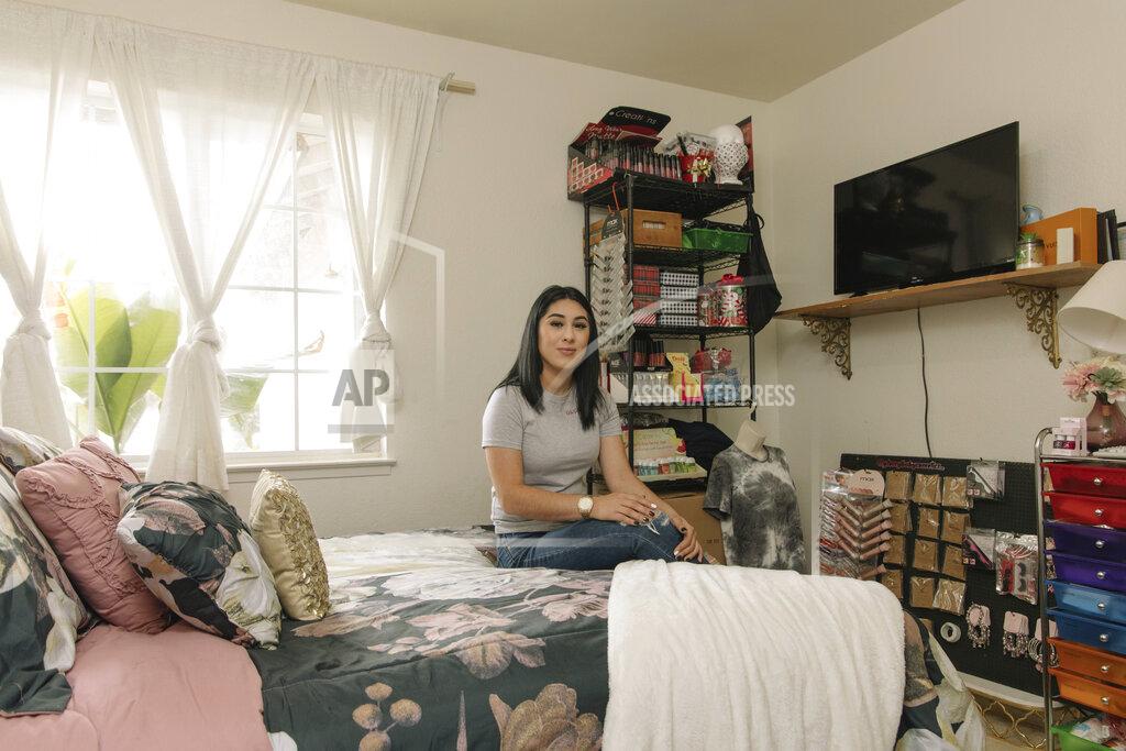 Madeline Tolle Alexandra Orozco sits in her bedroom where she runs her beauty company, Glossy Baby Cosmetics, in Delano, Calif., on Sunday, Dec. 6, 2020. She’s currently making an estimated $200-300 per month in sales from her new online business, nearly five times less than her salary at J.C. Penney. (Madeline Tolle/The Fuller Project via AP)
