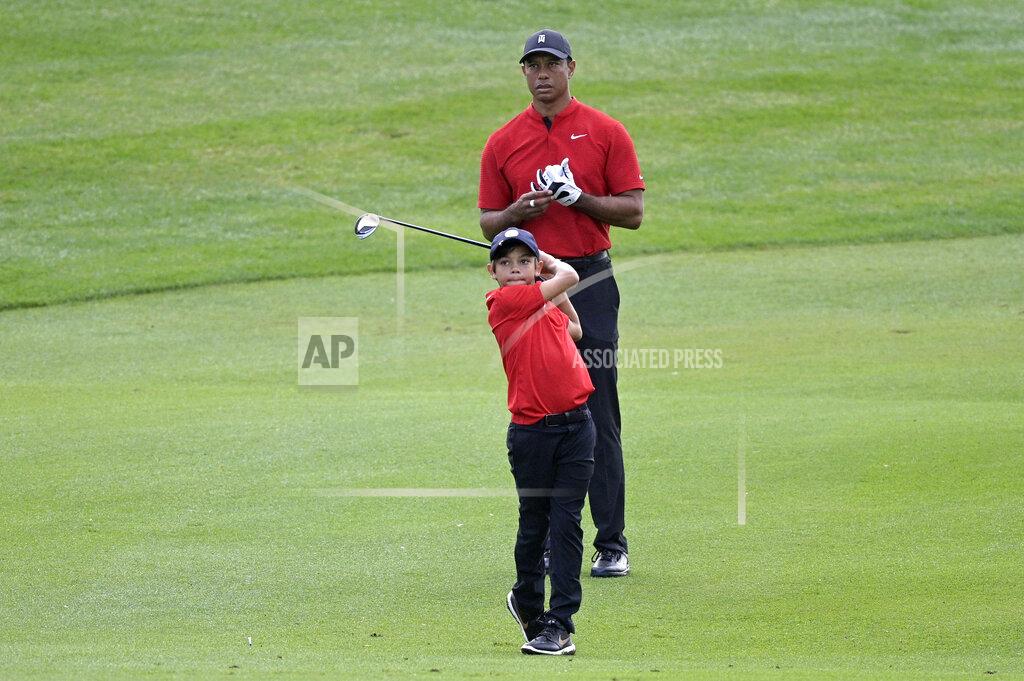 Phelan M. Ebenhack Tiger Woods watches his son Charlie's shot from the third fairway during the final round of the PNC Championship golf tournament, Sunday, Dec. 20, 2020, in Orlando, Fla. (AP Photo/Phelan M. Ebenhack)