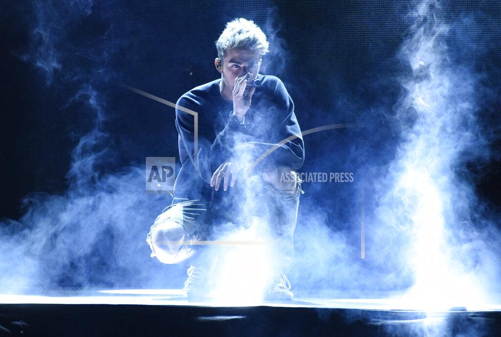 Chris Pizzello FILE - In this April 19, 2018 file photo, Andrew Taggart, of The Chainsmokers, performs "Sick Boy" at WE Day California at The Forum in Inglewood, Calif. New York's governor says he is "appalled" by videos showing crowds standing close together at a Hamptons concert featuring The Chainsmokers over the weekend. Gov. Andrew Cuomo said the state Department of Health will conduct an investigation into "egregious social distancing violations." The Saturday night concert on July 25, 2020, was billed as a charity drive-in show called "Safe & Sound" where Goldman Sachs' CEO and the Southampton town supervisor also performed. (Photo by Chris Pizzello/Invision/AP, File)
