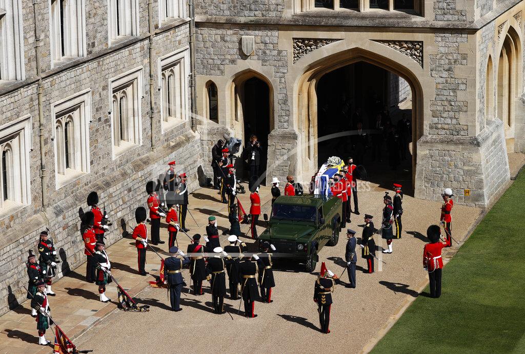 Adrian Dennis Members of the 1st Battalion Grenadier Guards place the coffin of Britain's Prince Philip onto a modified Jaguar Land Rover in the Quadrangle at Windsor Castle in Windsor, England, Saturday, April 17, 2021 ahead of the funeral of Britain's Prince Philip. Prince Philip died April 9 at the age of 99 after 73 years of marriage to Britain's Queen Elizabeth II. (Adrian Dennis/Pool via AP)