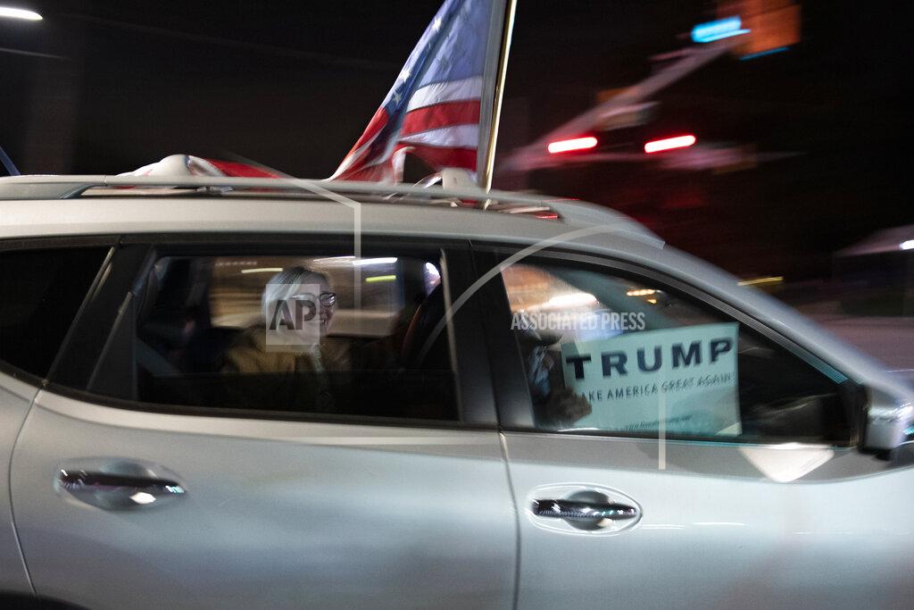 Cliff Owen Supporters of President Donald Trump drive past the entrance to Walter Reed National Military Medical Center in Bethesda, Md., Sunday, Oct. 4, 2020. Trump was admitted to the hospital after contracting the coronavirus. (AP Photo/Cliff Owen)