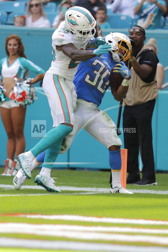 Lynne Sladky Los Angeles Chargers running back Austin Ekeler (30) scores a touchdown as Miami Dolphins cornerback Xavien Howard (25) attempts to tackle, during the first half at an NFL football game, Sunday, Sept. 29, 2019, in Miami Gardens, Fla. AP Photo/Lynne Sladky)
