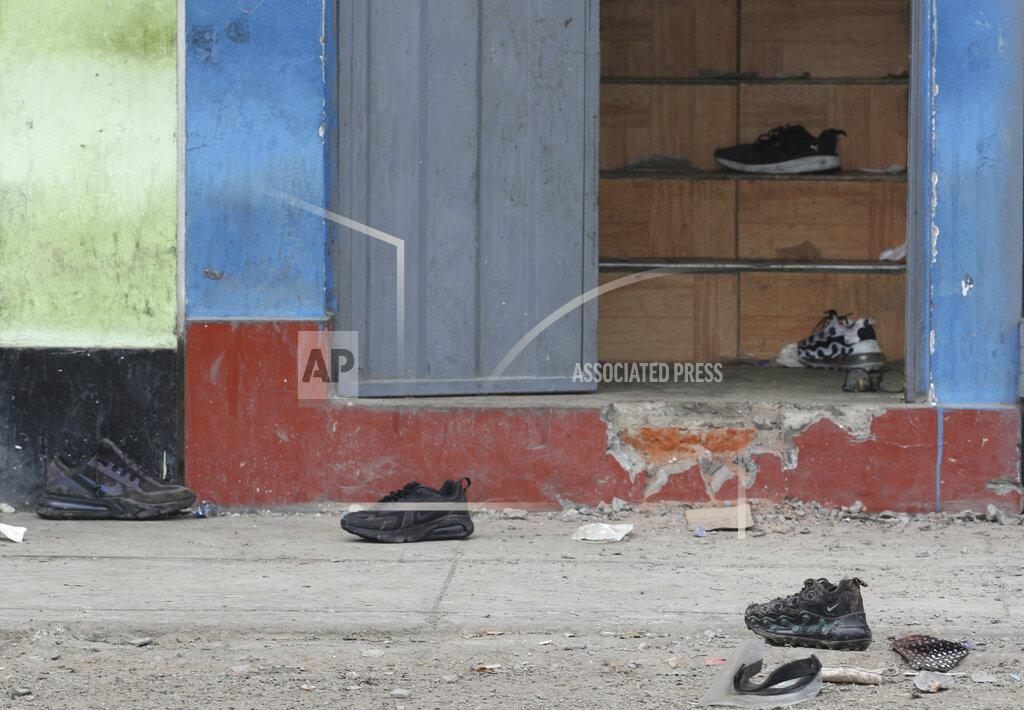 Martin Mejia Discarded shoes, masks, and a face shield, litter the entrance to the Tomas Restobar disco where officials say 13 people died in a stampede after a police raid to enforce the country's lockdown during the coronavirus pandemic, Sunday, Aug. 23, 2020. The stampede happened when about 120 people that had gathered for a party on Saturday night, tried to escape through the only door of the second-floor disco, trampling one another and becoming trapped in the confined space, according to authorities. (AP Photo/Martin Mejia)