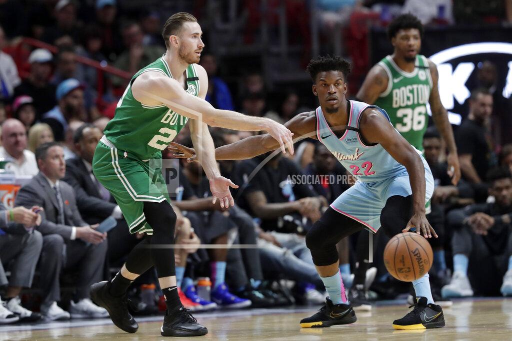 Boston Celtics forward Gordon Hayward, left, passes as Miami Heat forward Jimmy Butler (22) defends during the first half of an NBA basketball game, Tuesday, Jan. 28, 2020, in Miami. (AP Photo/Lynne Sladky)