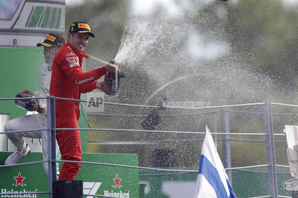 Ferrari driver Charles Leclerc of Monaco sprays champagne as celebrates on podium after winning the Formula One Italy Grand Prix at the Monza racetrack, in Monza, Italy, Sunday, Sept. 8, 2019. (AP Photo/Luca Bruno)
