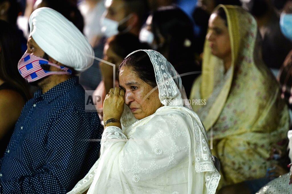 Ross D. Franklin Harjinder Kaur Sodhi, wife of murder victim Balbir Singh Sodhi, wipes a tear away at a memorial service on the 20th anniversary of the murder of Balbir Singh Sodhi, as she sits next to Rana Singh Sodhi, left, brother of Balbir, Wednesday, Sept. 15, 2021, in Mesa, Ariz. Sikh businessman Balbir Singh Sodhi was helping plant a flower bed at his Arizona gas station when he was shot dead by a man seeking to avenge 9/11. Mistaken for an Arab Muslim because of his turban and beard, Sodhi was the first person to die in a wave of bias crimes unleashed by the attacks. (AP Photo/Ross D. Franklin)