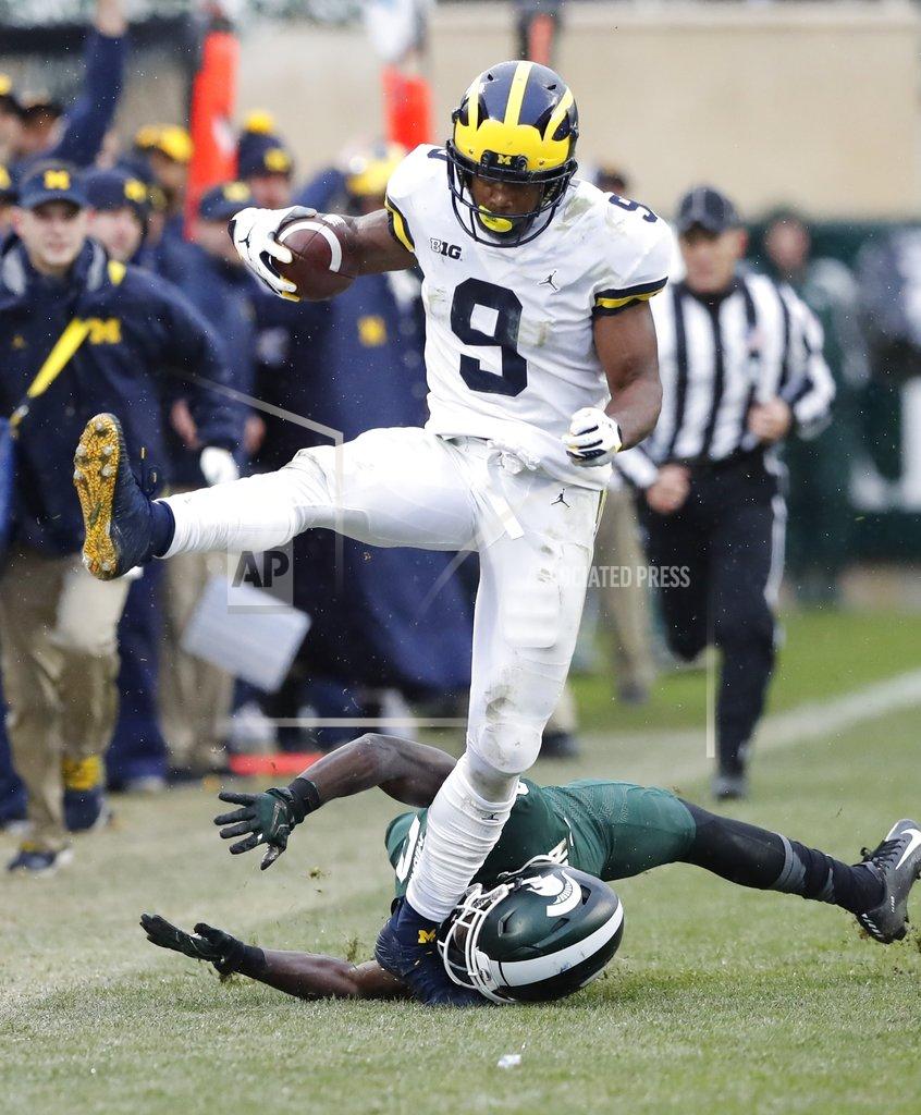 Carlos Osorio Michigan wide receiver Donovan Peoples-Jones (9) jumps over Michigan State safety Tre Person (24) enroute to a 79-yard touchdown run during the second half of an NCAA college football game, Saturday, Oct. 20, 2018, in East Lansing, Mich. (AP Photo/Carlos Osorio)