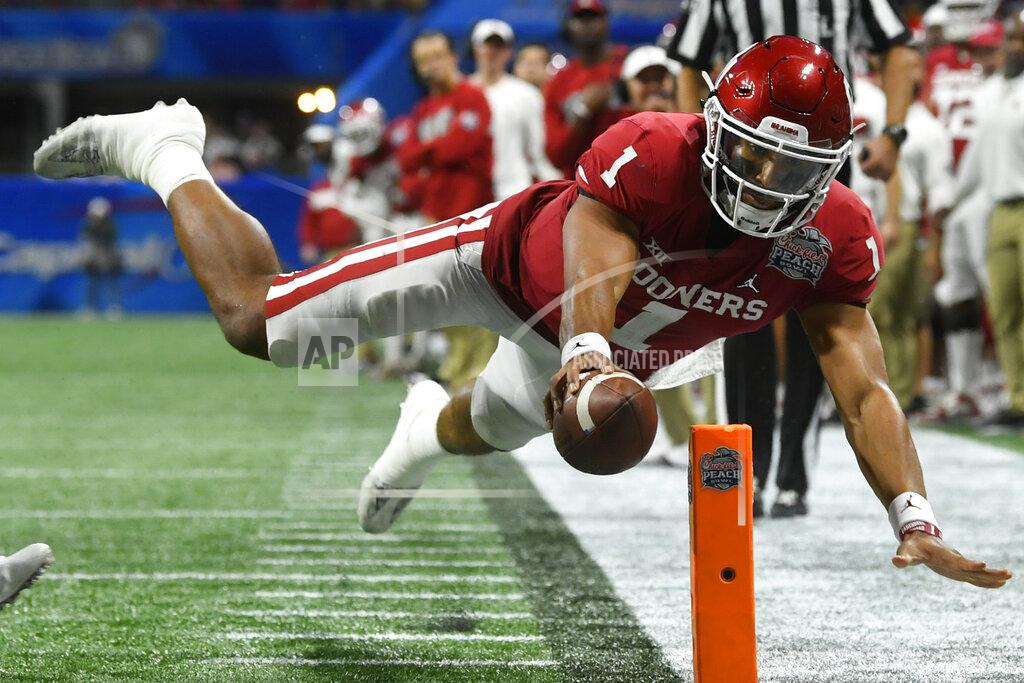 John Amis Oklahoma quarterback Jalen Hurts (1) scores a touchdown against LSU during the second half of the Peach Bowl NCAA semifinal college football playoff game, Saturday, Dec. 28, 2019, in Atlanta. (AP Photo/John Amis)