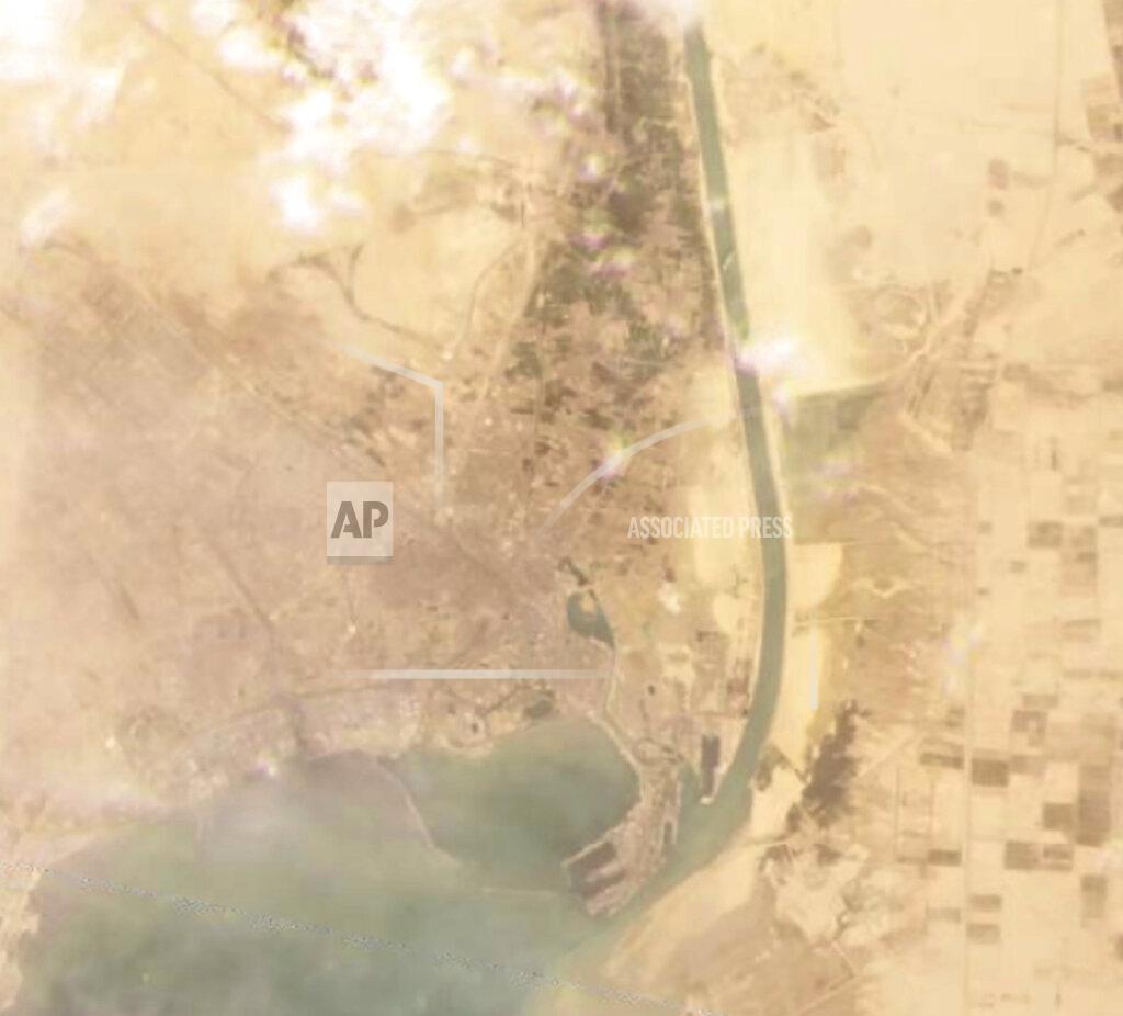 Planet Labs Inc. This satellite image from Planet Labs Inc. shows the cargo ship MV Ever Given stuck in the Suez Canal near Suez, Egypt, Tuesday, March 23, 2021. A cargo container ship that's among the largest in the world has turned sideways and blocked all traffic in Egypt's Suez Canal, officials said Wednesday, March 24, 2021, threatening to disrupt a global shipping system already strained by the coronavirus pandemic. (Planet Labs Inc. via AP)