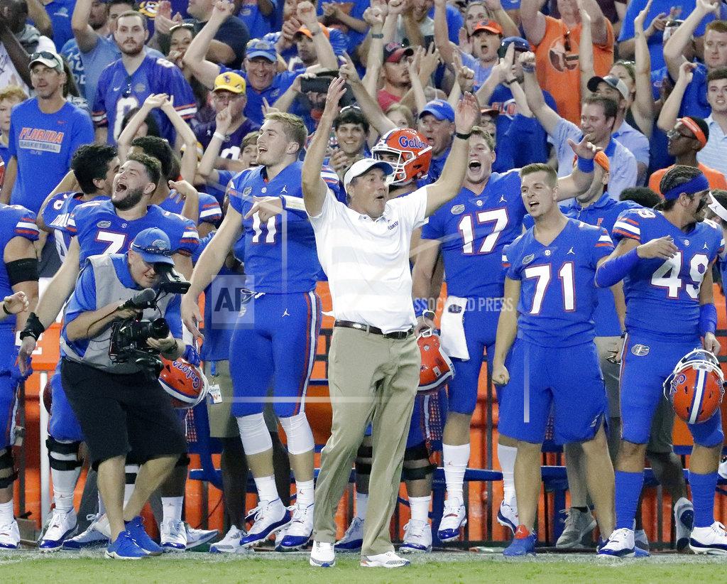 John Raoux FILE - In this Oct. 6, 2018, file photo, Florida head coach Dan Mullen, center, celebrates with players on the sidelines during the final moments of an NCAA college football game against LSU, in Gainesville, Fla. Mullen opened his first team meeting this week talking about handling success. He'll find out Saturday if anyone was paying attention.(AP Photo/John Raoux, File)
