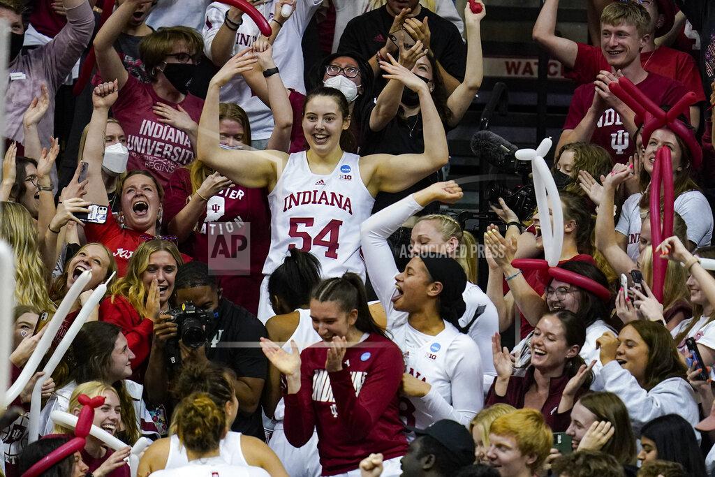 Michael Conroy Indiana forward Mackenzie Holmes (54) along with her teammates celebrate in the stands after a 56-55 win over Princeton in a college basketball game in the second round of the NCAA tournament in Bloomington, Ind., Monday, March 21, 2022. (AP Photo/Michael Conroy)
