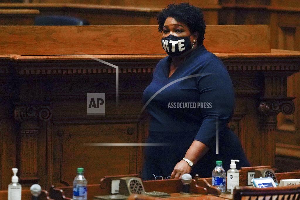 John Bazemore FILE - In this Dec. 14, 2020, file photo Democrat Stacey Abrams, walks on Senate floor before of members of Georgia's Electoral College cast their votes at the state Capitol in Atlanta. Abrams, Georgia's well-known voting rights advocate, is taking a carefully balanced approach in response to new laws many people have said are an attempt to suppress votes of people of color. When asked about the law changes, she is critical but measured. (AP Photo/John Bazemore, Pool, File)