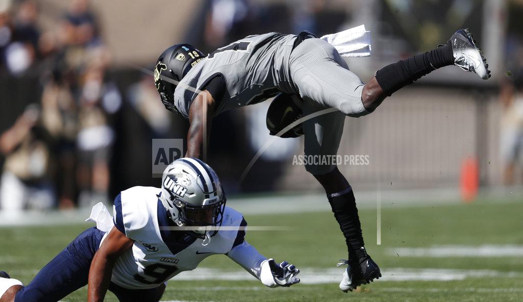 David Zalubowski New Hampshire cornerback Isiah Perkins, left, trips up Colorado wide receiver Tony Brown after he pulled in a pass in the first half of an NCAA college football game Saturday, Sept. 15, 2018, in Boulder, Colo. (AP Photo/David Zalubowski)