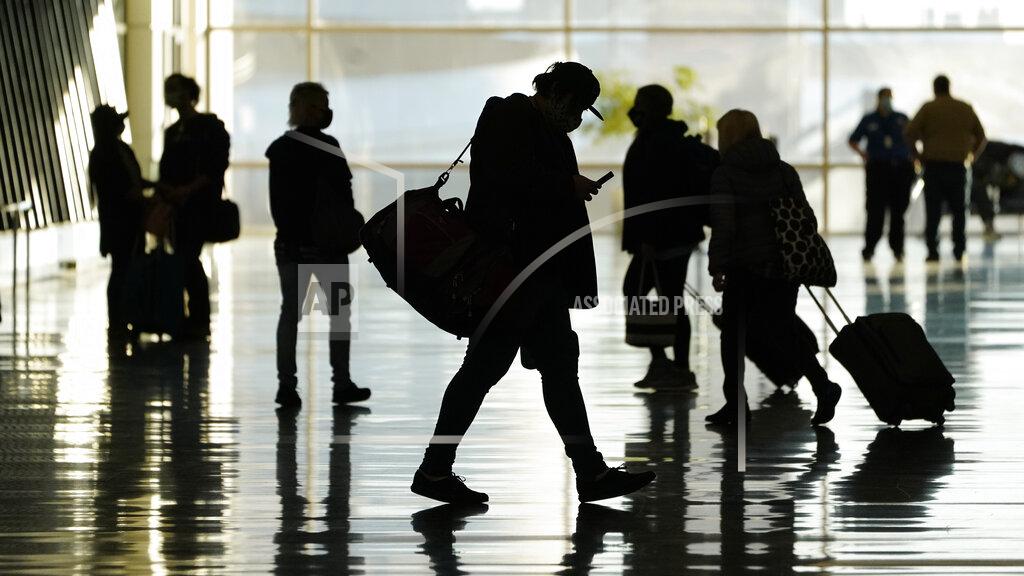 FILE - In this Oct. 27, 2020, file photo, passengers walk through Salt Lake City International Airport, in Salt Lake City. Business travel might never look the same in the wake of the coronavirus. Consulting firm McKinsey and Co. says it took international business travel five years to recover after the 2008 recession. But this time, the ease of videoconferencing could put a permanent dent in corporate trips. (AP Photo/Rick Bowmer, File)