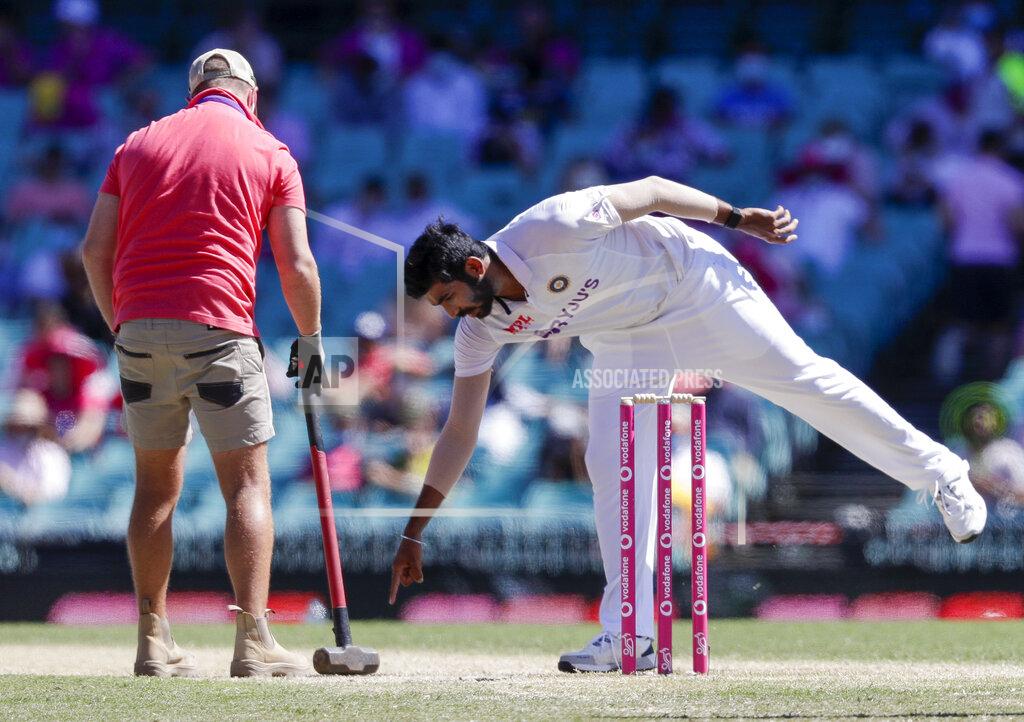 Rick Rycroft Indian bowler Jasprit Bumrah points to the pitch for a groundsman to work on during play on day three of the third cricket test between India and Australia at the Sydney Cricket Ground, Sydney, Australia, Saturday, Jan. 9, 2021. (AP Photo/Rick Rycroft)
