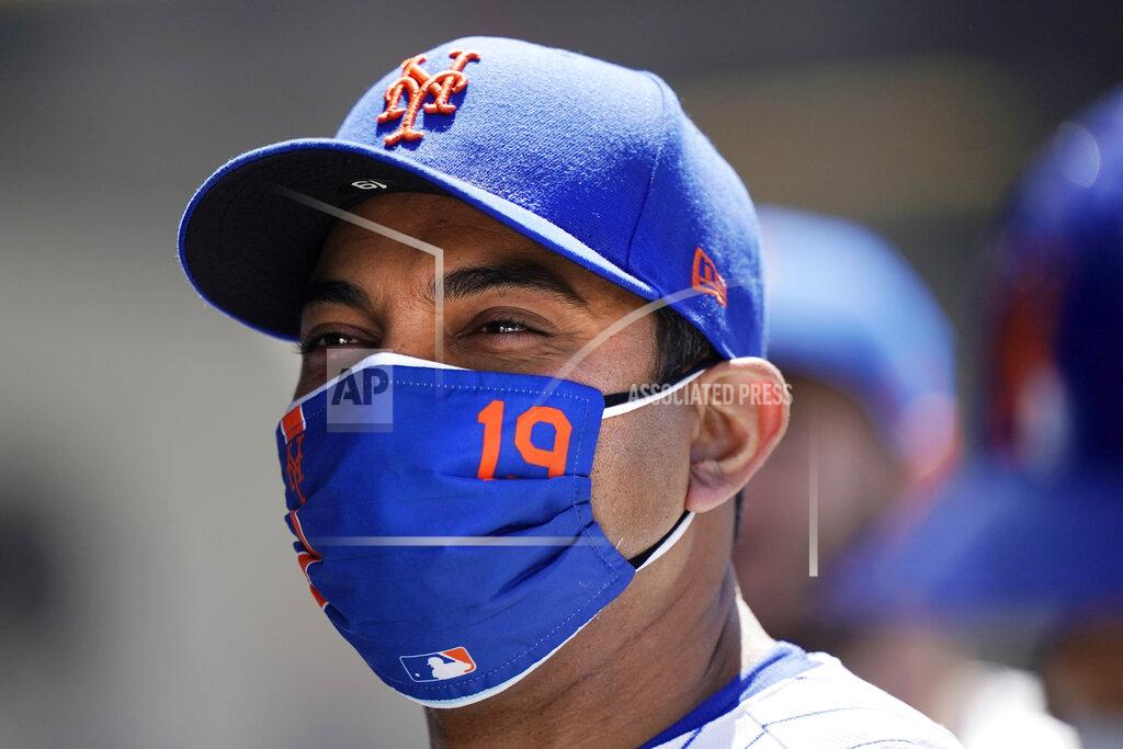 Kathy Willens New York Mets manager Luis Rojas (19) appears to smile beneath his mask between innings of the Mets 7-1 victory over the Baltimore Orioles in a baseball game, Wednesday, May 12, 2021, in New York. The Mets swept the Orioles in a two-game series. (AP Photo/Kathy Willens)