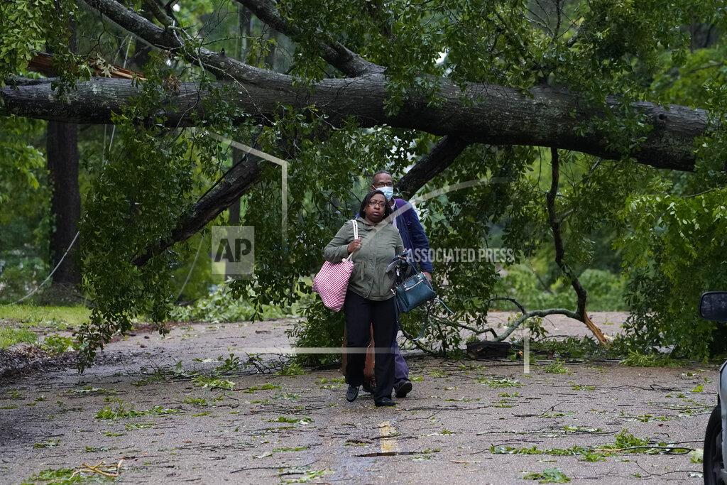 Rogelio V. Solis Northeast Jackson, Miss., residents leave their powerless home after utility lines were brought down by trees and debris spread by high winds Tuesday, May 4, 2021. The severe weather was not unexpected, since the state was hit with a number of tornadoes on Sunday. (AP Photo/Rogelio V. Solis)