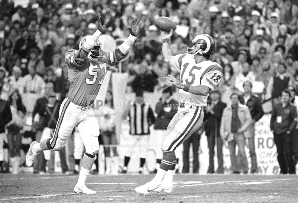 Uncredited FILE - In this Sunday, Jan. 6, 1980, file photo, Tampa Bay Buccaneers' David Lewis, left, pressures Los Angeles Rams quarterback Vince Ferragamo during the NFC championship NFL football game in Tampa. Lewis, a key member of the Buccaneers’ historic 1979 team that reached the NFC title game, has died. He was 65. Lewis died Tuesday, July 14, 2020, in Tampa. The cause was not immediately known, but he had struggled with health issues in recent years. (AP Photo/File)