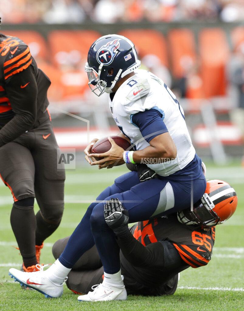 Ron Schwane Cleveland Browns defensive tackle Larry Ogunjobi (65) sacks Tennessee Titans quarterback Marcus Mariota (8) during the second half in an NFL football game Sunday, Sept. 8, 2019, in Cleveland. (AP Photo/Ron Schwane)