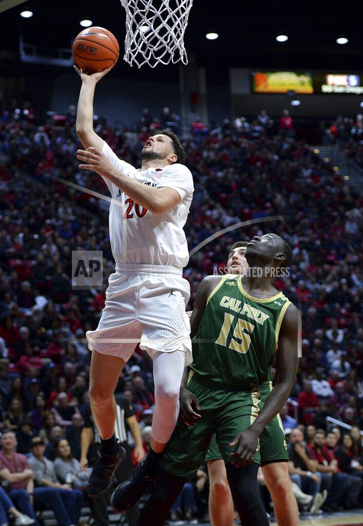 Orlando Ramirez San Diego State guard Jordan Schakel (20) goes to the basket as Cal Poly forward Alimamy Koroma (15) watches during the first half of an NCAA college basketball game Saturday, Dec. 28, 2019, in San Diego. (AP Photo/Orlando Ramirez)