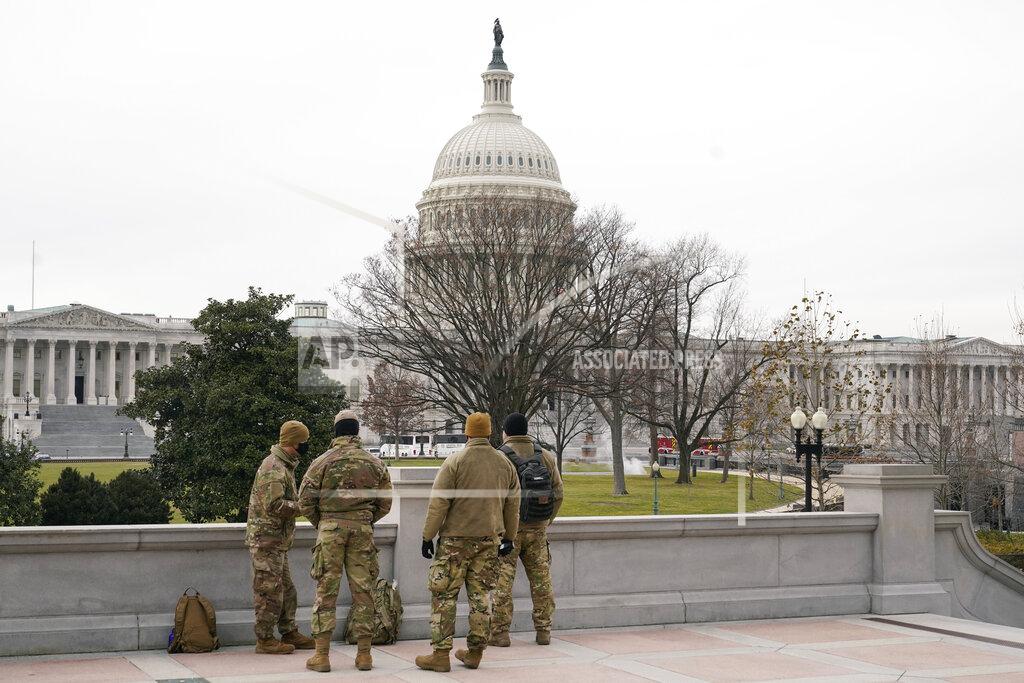 Patrick Semansky With the U.S. Capitol Building in view, members of the military stand on the steps of the Library of Congress' Thomas Jefferson Building in Washington, Friday, Jan. 8, 2021, in response to supporters of President Donald Trump who stormed the Capitol. (AP Photo/Patrick Semansky)