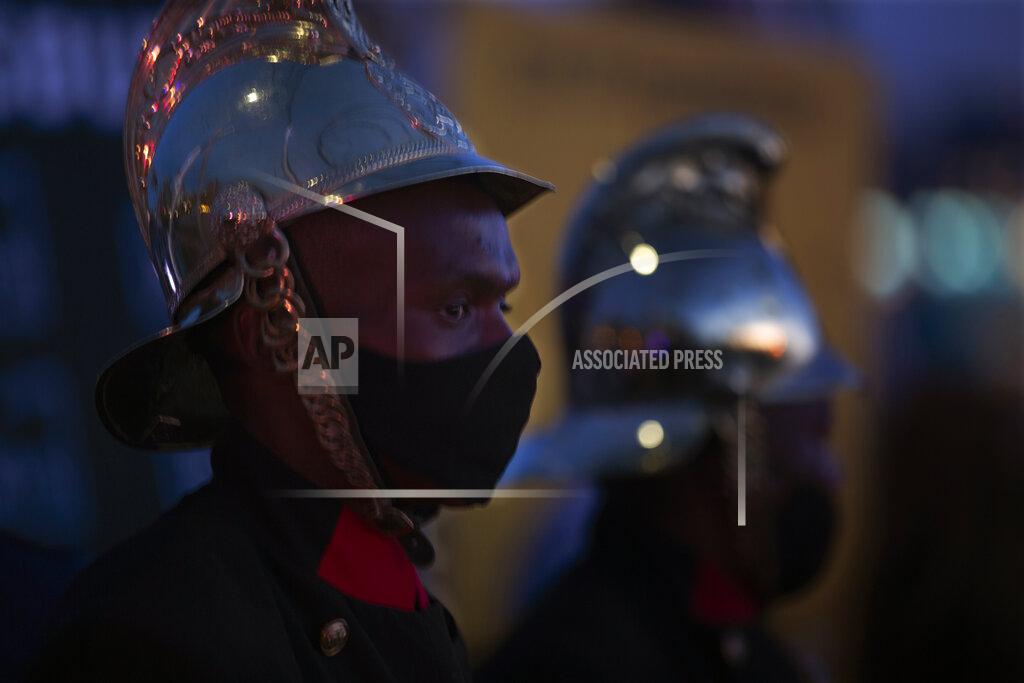 Denis Farrell Firemen join frontline workers at a candlelight ceremony on New Year's Eve on the famed Nelson Mandela Bridge in downtown Johannesburg Thursday, Dec. 31, 2020. Many South Africans will swap firecrackers for candles to mark New Year's Eve amid COVID-19 restrictions including a nighttime curfew responding to President Cyril Ramaphosa's call to light a candle to honor those who have died in the COVID-19 pandemic and the health workers who are on the frontline of battling the disease. (AP Photo/Denis Farrell)