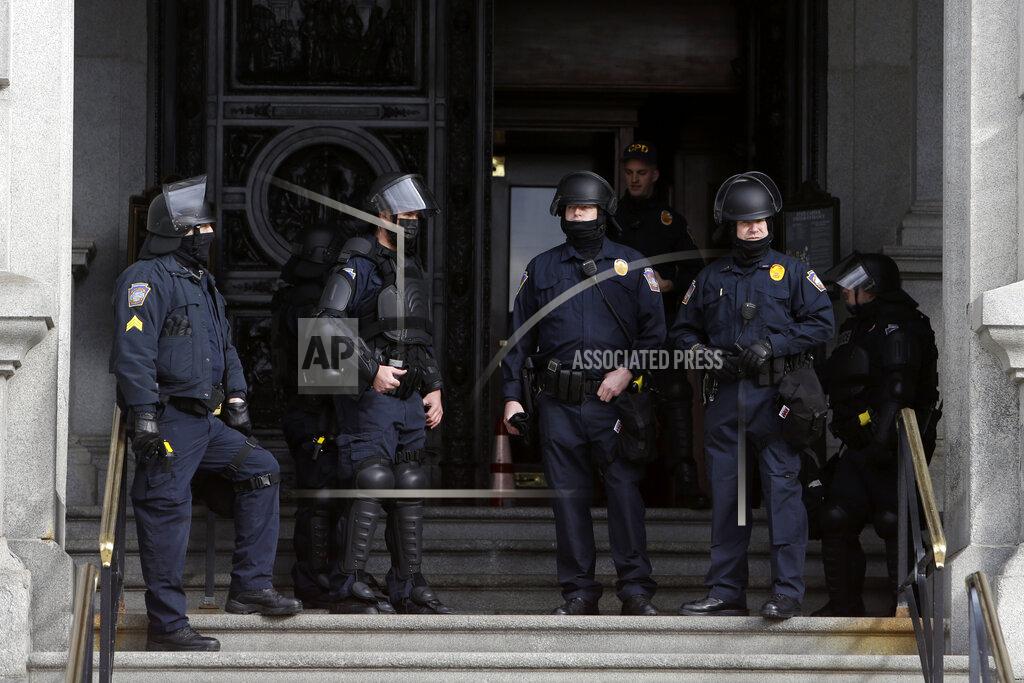 Jacqueline Larma Capitol Police stand at the main entrance of the Pennsylvania State Capitol Sunday Jan. 17, 2021 in Harrisburg, Pa. (AP Photo/Jacqueline Larma)