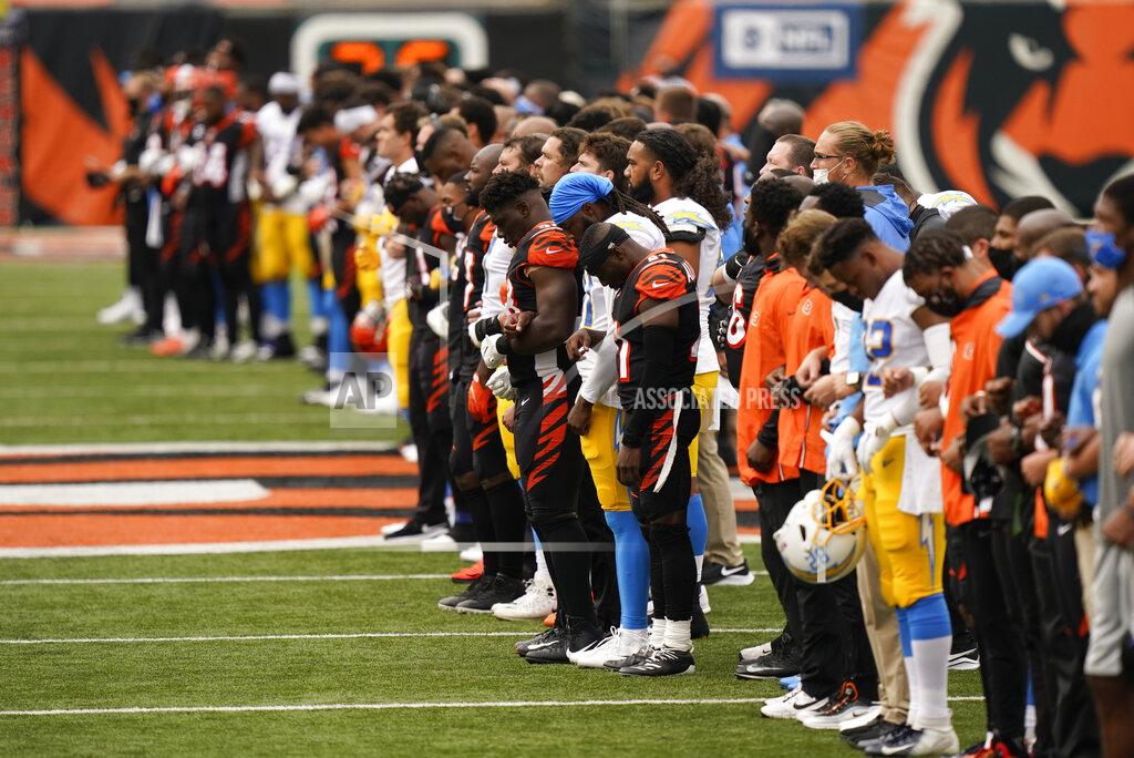 Bryan Woolston The Cincinnati Bengals and Los Angeles Chargers stand together arm in arm before for an NFL football game, Sunday, Sept. 13, 2020, in Cincinnati. (AP Photo/Bryan Woolston)