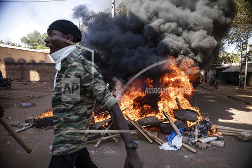 Protestors take to the streets of Burkina Faso's capital Ouagadougou Saturday Nov. 27, 2021, calling for President Roch Marc Christian Kabore to resign. The protest comes after the deadliest attack in years against the security forces in the Sahel's Soum province earlier this month, where more than 50 security forces were killed and after an attack in the Center North region where 19 people including nine members of the security forces were killed. (AP Photo/Sophie Garcia)