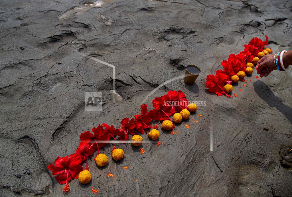 Anupam Nath A Hindu woman performs rituals during a prayer ceremony to rid the world of coronavirus, on the banks of the river Brahmaputra in Gauhati, India, Friday, June 5, 2020. (AP Photo/Anupam Nath)