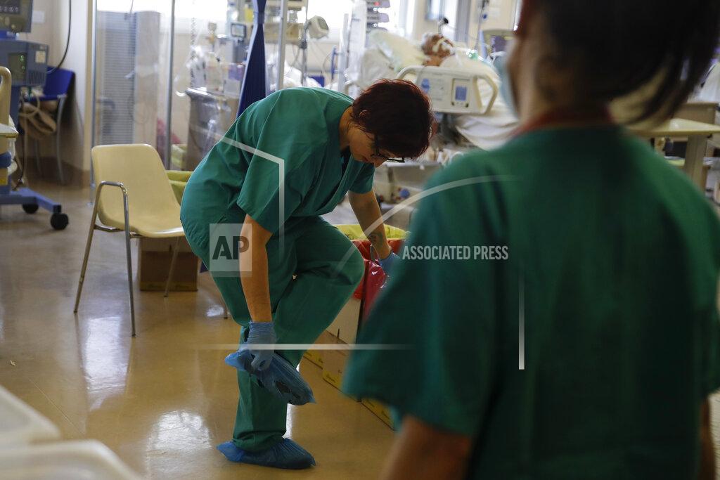 Luca Bruno Paramedic Alessandra works at the Intensive Care Unit of Varese’s Circolo Hospital, in Varese, Italy, Friday, Nov. 6, 2020. During Italy's autumn pandemic resurgence, concern is falling less on intensive care wards and more on regular medical wards, as eight regions have seen the needle move alarmingly into the red-alert zone with more than half of hospital beds dedicated to coronavirus patients. (AP Photo/Luca Bruno)
