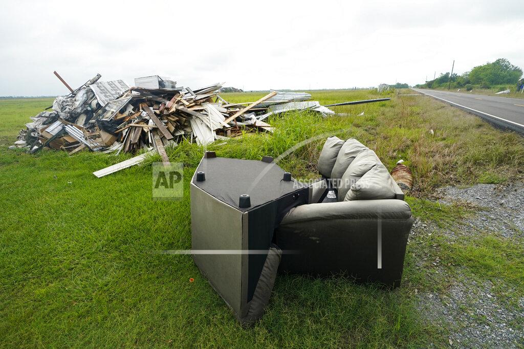 Gerald Herbert Debris from Hurricane Laura is pilled up in Bell City, La., Thursday, Oct. 8, 2020, as Hurricane Delta approached the Gulf Coast. Louisiana residents still recovering from the devastation of a powerful hurricane less than two months ago braced for another hit as Hurricane Delta steamed north through the Gulf on Thursday after swiping Mexico's Yucatan Peninsula. (AP Photo/Gerald Herbert)