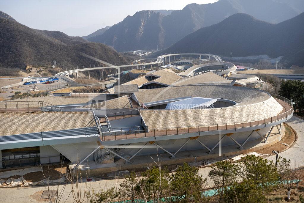 Mark Schiefelbein The curving track of the National Sledding Center is seen in Yanqing on the outskirts of Beijing, Friday, Feb. 5, 2021. Beijing Olympic organizers showed off the downhill skiing venue and the world's longest bobsled and luge track Friday, one year ahead of the scheduled opening of the 2022 Olympic Winter Games. (AP Photo/Mark Schiefelbein)