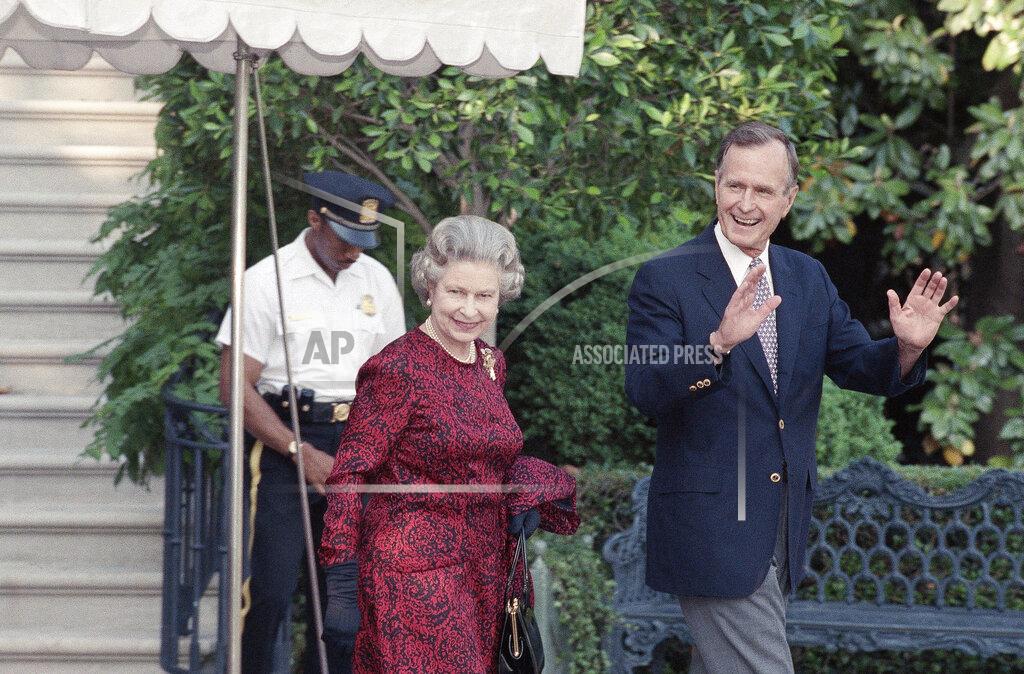 Doug Mills FILE - In this May 15, 1991 file photo, U.S. President George H.W. Bush escorts Queen Elizabeth II from the White House to a helicopter en route to Baltimore to watch her first major league baseball game, in Washington. (AP Photo/Doug Mills, File)