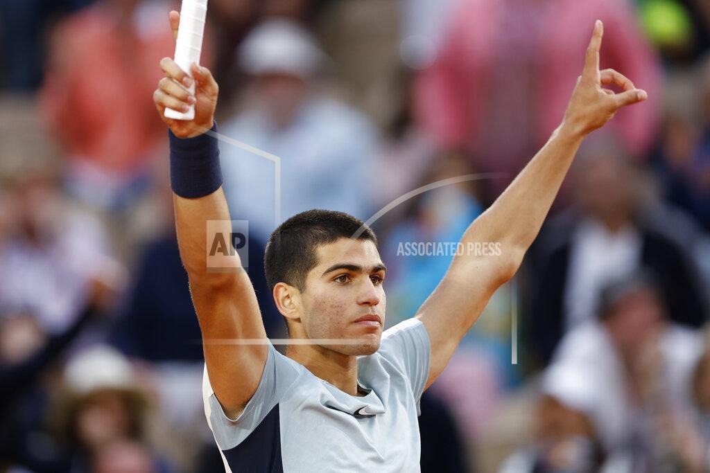 Jean-Francois Badias Spain's Carlos Alcaraz celebrates winning against Spain's Albert Ramos-Vinolas in five sets, 6-1, 6-7 (9-7), 5-7, 7-6 (7-2), 6-4, during their second round match at the French Open tennis tournament in Roland Garros stadium in Paris, France, Wednesday, May 25, 2022. (AP Photo/Jean-Francois Badias)