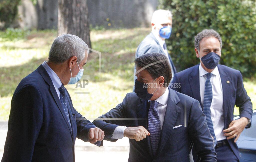Riccardo De Luca Italian Premier Giuseppe Conte, right, touch elbows with Civil Protection head Angelo Borrelli as he arrives for a thanksgiving ceremony dedicated to physicians and nurses, in Rome, Monday, June 22, 2020. (AP Photo/Riccardo De Luca)
