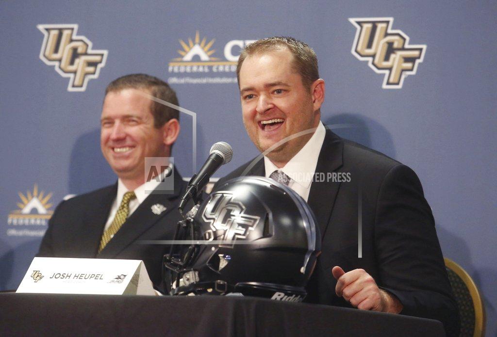 Red Huber FILE - In this Dec. 5, 2017, file photo, Josh Heupel, right, is introduced as the new Central Florida head football coach by Danny White, UCF Athletic director, in Orlando, Fla. Josh Heupel has either the most difficult job of any head coach in the country taking over a new team this season or the easiest. (Red Huber/Orlando Sentinel via AP, File)