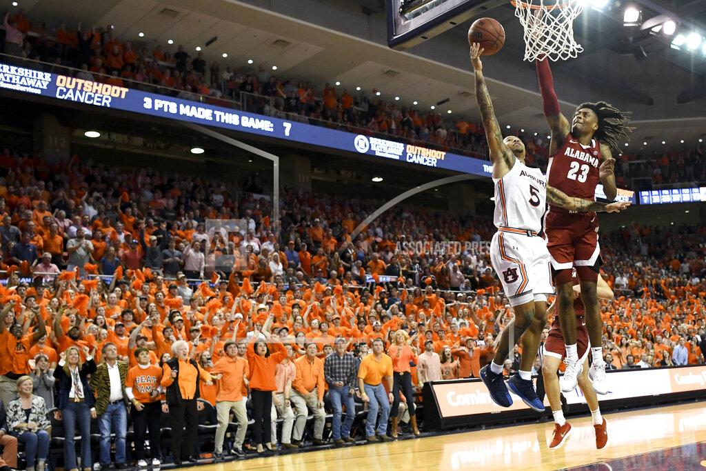 Julie Bennett Alabama guard John Petty Jr. (23) defends a shot by Auburn guard J'Von McCormick (5) during overtime of an NCAA college basketball game, Wednesday, Feb. 12, 2020, in Auburn, Ala. (AP Photo/Julie Bennett)