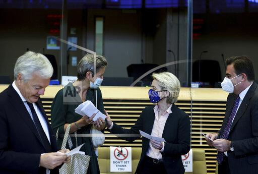 From left, European Commissioner for Justice Didier Reynders, European Commission Vice-President in charge Europe Fit for the Digital Age Margrethe Vestager, European Commission President Ursula von der Leyen and European Commission Vice-President in charge for Promoting our European Way of Life Margaritis Schinas speak prior to a meeting of the College of Commissioners at EU headquarters in Brussels, Wednesday, Oct. 27, 2021. (Kenzo Tribouillard, Pool Photo via AP)