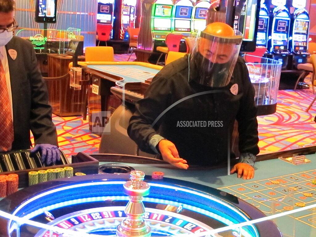 Wayne Parry A dealer conducts a game of roulette at the Hard Rock Casino in Atlantic City N.J. on July 2, 2020, the first day the casino was allowed to reopen during the coronavirus pandemic. Figures released on April 9, 2021, show Atlantic City's nine casinos collectively saw their gross operating profits decline by more than 80% in 2020. (AP Photo/Wayne Parry)