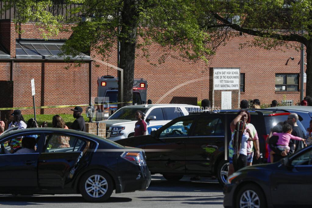 Wade Payne People gather outside Austin East High School in Knoxville, Tenn., as Knoxville police work the scene following a shooting at the school Monday, April 12, 2021. (AP Photo/Wade Payne)