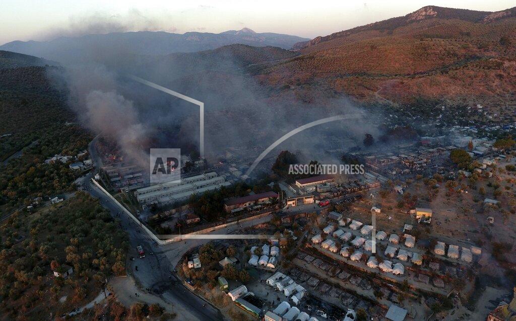 Panagiotis Balaskas FILE - In this Wednesday, Sept. 9, 2020 file photo, fire burns container houses and tents in the Moria refugee camp on the northeastern Aegean island of Lesbos, Greece. Five years on, the deal between European Union and Turkey is no longer working but at a summit next week EU leaders will discuss ways to improve relations with Turkey and could try to revive the agreement. (AP Photo/Panagiotis Balaskas, File)