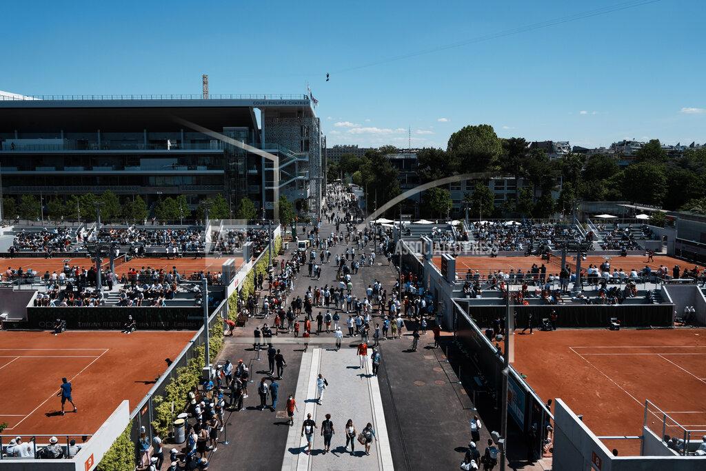 Thibault Camus Visitors stroll in the alleys of the Roland Garros stadium during the French Open tennis tournament, Sunday, May 30, 2021 in Paris. (AP Photo/Thibault Camus)