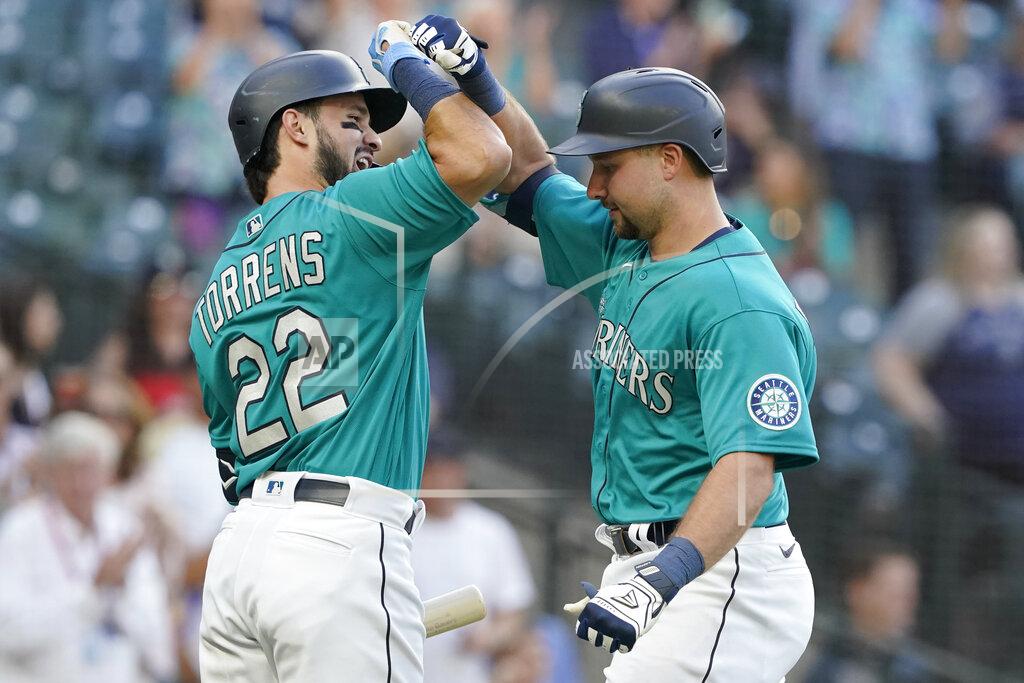 Ted S. Warren Seattle Mariners' Cal Raleigh, right, is greed by Luis Torrens (22) after Raleigh hit a two-run home run against the Oakland Athletics during the second inning of a baseball game, Friday, July 23, 2021, in Seattle. Torrens hit a solo home run in his ensuing at-bat. (AP Photo/Ted S. Warren)