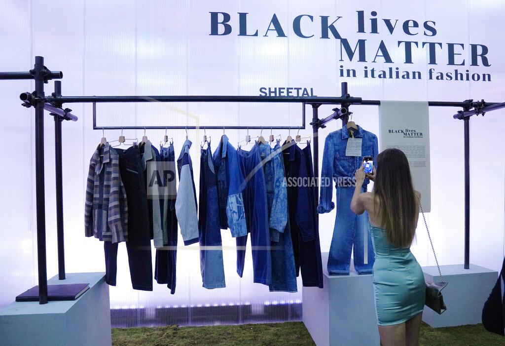 Antonio Calanni A woman takes pictures of fashion designer Sheetal's creations, as part of the Black Lives Matter Spring Summer 2022 collective fashion event, unveiled during the Milan Fashion Week, in Milan, Italy, Tuesday, Sept. 21, 2021. (AP Photo/Antonio Calanni)