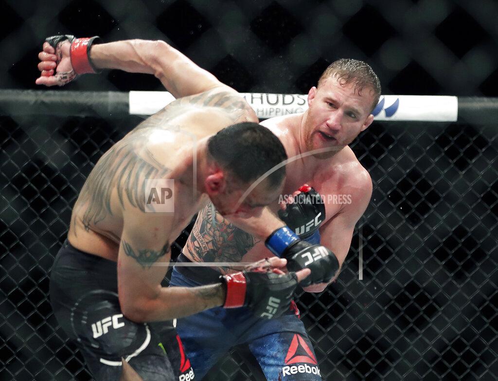 John Raoux FILE - In this May 10, 2020, file photo, Tony Ferguson, left, falls backward after taking a punch from Justin Gaethje during a UFC 249 mixed martial arts boutin Jacksonville, Fla. Khabib Nurmagomedov will risk his unbeaten record and his UFC lightweight title against interim champion Gaethje in the main event of UFC 254 in Abu Dhabi on Saturday, Oct. 24, 2020. (AP Photo/John Raoux, File)