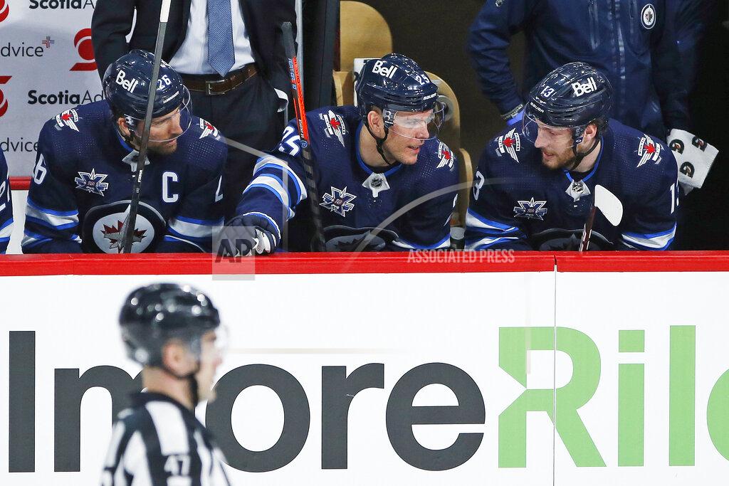 John Woods FILE - In this March 31, 2021, file photo, Winnipeg Jets' Blake Wheeler (26), Paul Stastny (25) and Pierre-Luc Dubois (13) talk between shifts during the first period of an NHL hockey game against the Toronto Maple Leafs in Winnipeg, Manitoba. Dubois is looking forward to finally getting to know his Jets teammates after spending much of last season in Winnipeg isolated from them due to COVID-19 protocols coupled with a rash of injuries. (John Woods/The Canadian Press via AP, File)