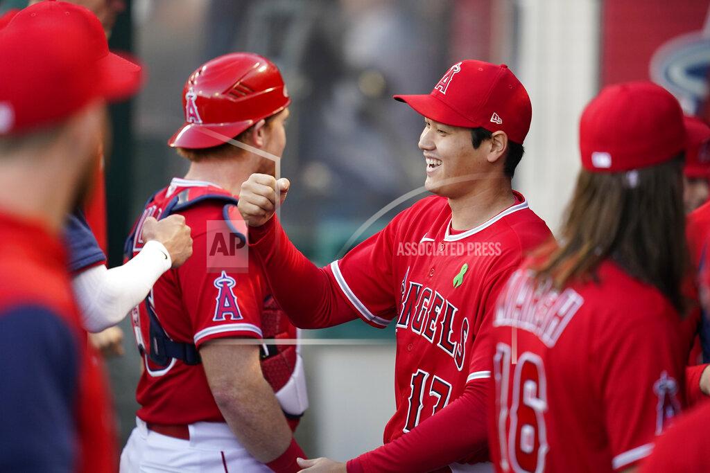 Ashley Landis Los Angeles Angels designated hitter Shohei Ohtani (17) celebrates in the dugout after a ceremony honoring him before a baseball game against the Tampa Bay Rays in Anaheim, Calif., Tuesday, May 10, 2022. Ohtani was presented with trophies for his 2021 American League Most Valuable Player award, his 2021 Louisville Slugger award, the Edgar Martinez Award, the Commissioner's Historic Achievement Award, and an All-MLB First and Second Team plaque. (AP Photo/Ashley Landis)