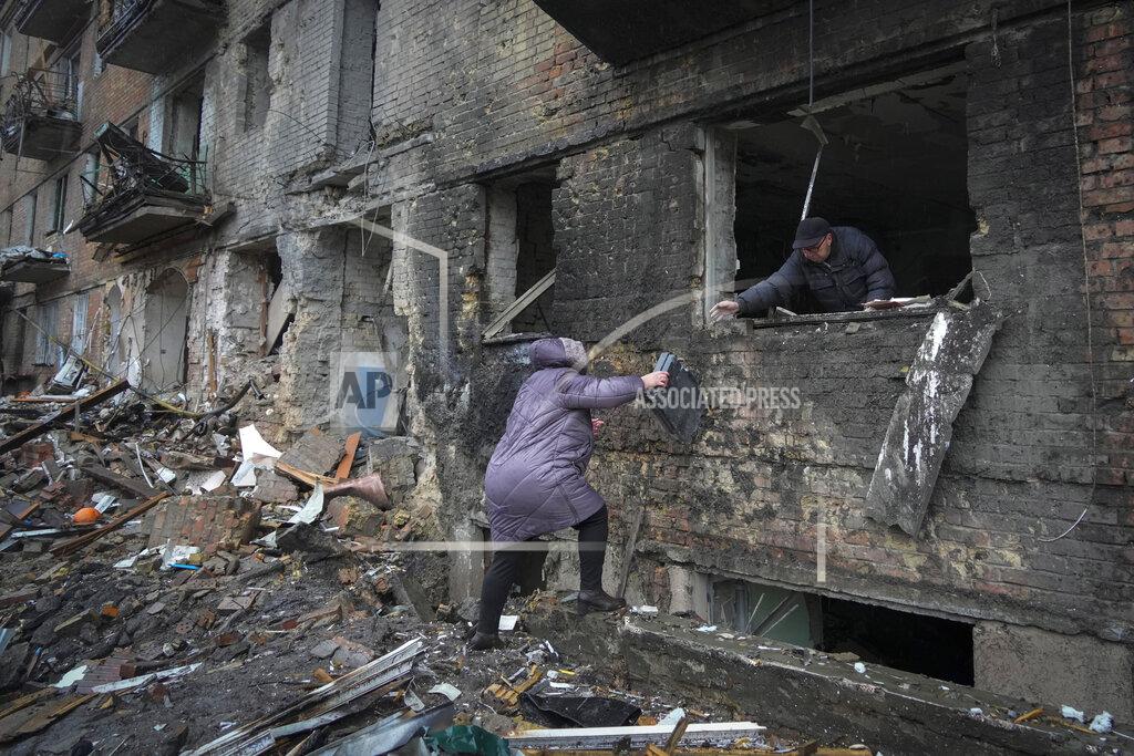 Efrem Lukatsky People gather their belongings from a damaged house after Russian shelling in the town of Vyshgorod outside the capital Kiev, Ukraine, Thursday, Nov. 24, 2022. About 70% of the Ukrainian capital was left without power on Thursday morning after Moscow unleashed yet another devastating missile barrage on Ukraine's energy infrastructure, Kyiv's mayor said. (AP Photo/Efrem Lukatsky)